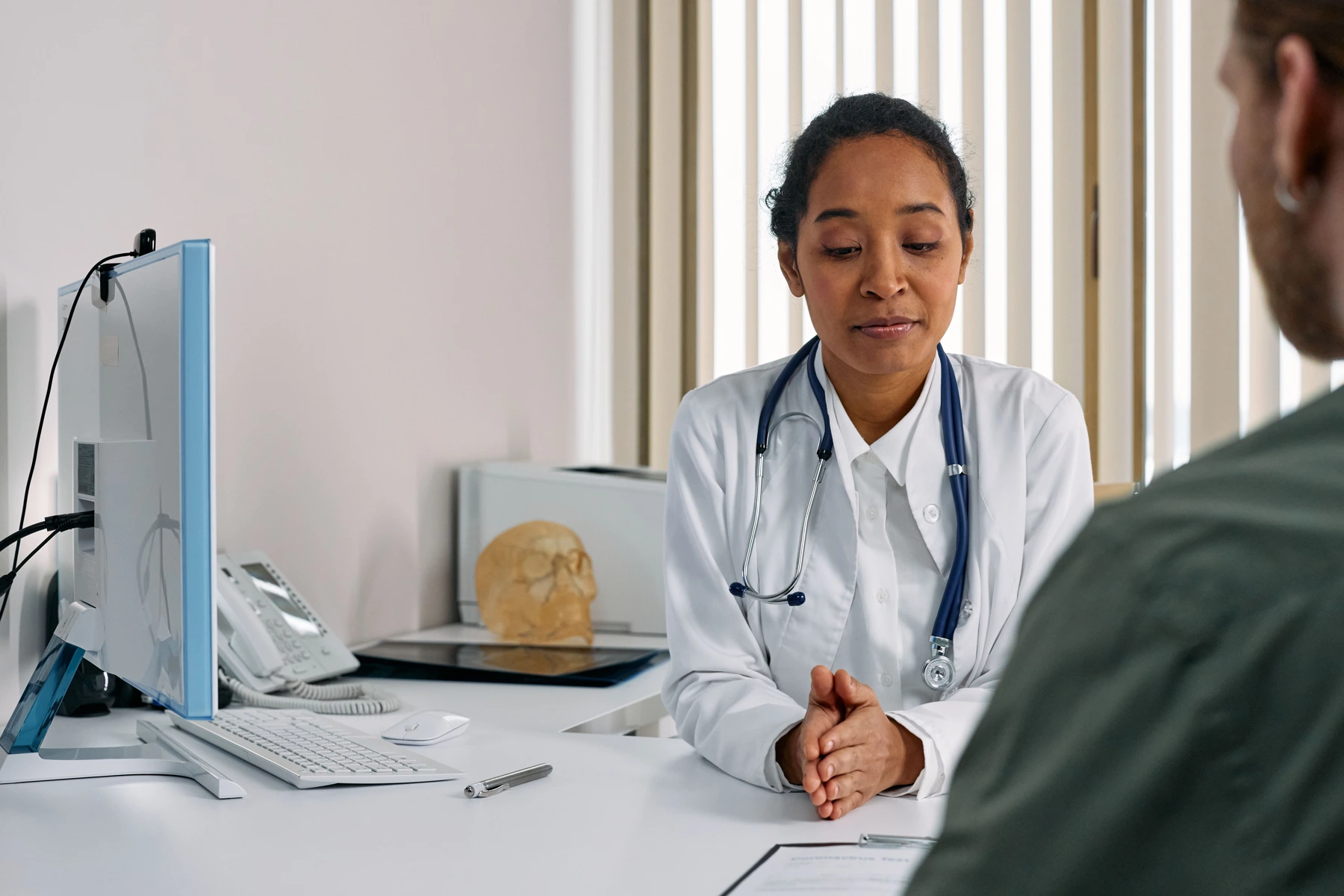 A doctor listening to a patient during a consultation