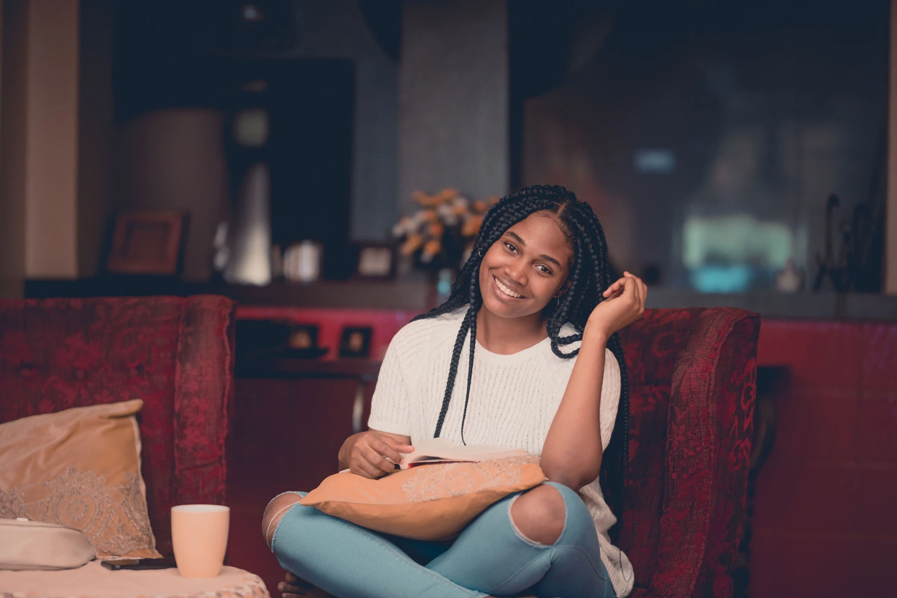 A woman relaxing with a book in a Lagos home